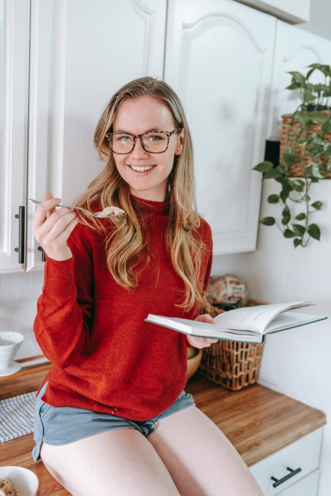 Girl eating food sitting on a counter for PCOS Nutrition