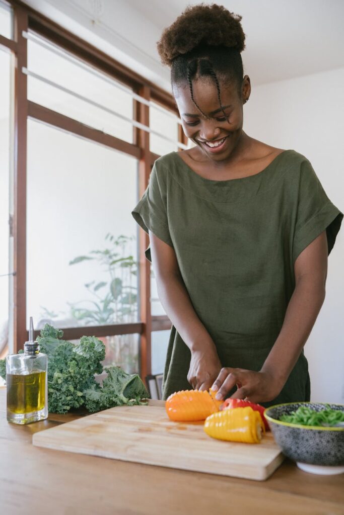 PCOS Weight Loss - woman in green tank top holding orange bell pepper